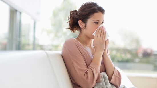 Woman blowing her nose