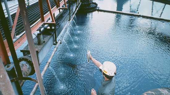 Ecolab filtration systems expert checking fluids for wastewater as a step in coagulant treatment.