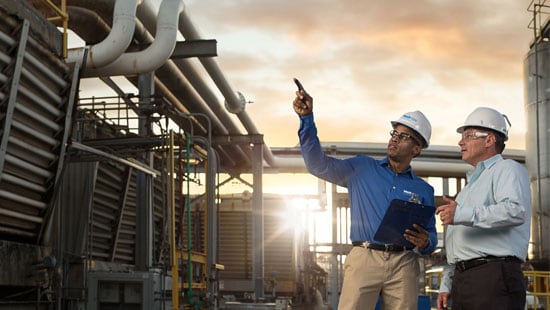 Two Men Reviewing Cooling Water Towers