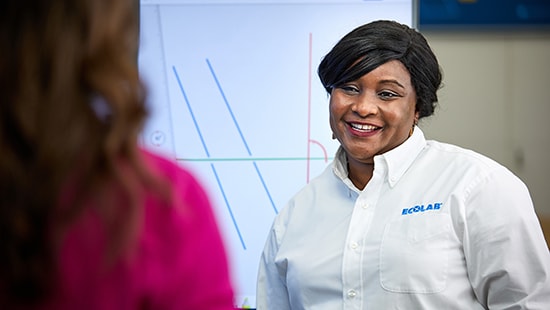 Ecolab expert smiling at another person