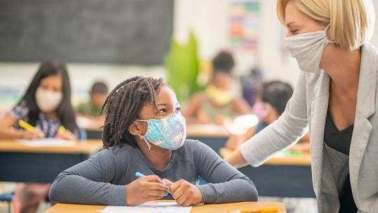 teacher student at desk with masks